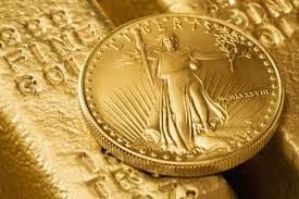 Liberty Gold Coin on Top of Bullion Bar