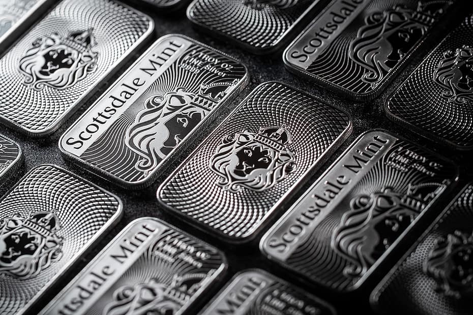 a pile of silver bars sitting on top of a table