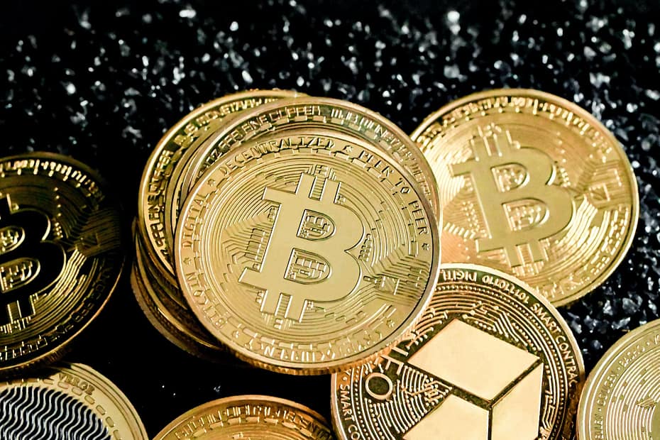 a pile of bitcoins sitting on top of a table
